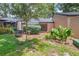 Serene backyard area with lush greenery, a birdbath, and chairs for enjoying the peaceful outdoor setting at 940 Douglas Ave # 159, Altamonte Springs, FL 32714
