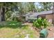 Landscaped backyard offering a tranquil escape with well-maintained lawn and mature trees providing shade at 940 Douglas Ave # 159, Altamonte Springs, FL 32714