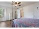 Bedroom featuring hardwood floors, a canopy bed, ceiling fan, and a closet with white painted doors at 940 Douglas Ave # 159, Altamonte Springs, FL 32714