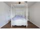 Bedroom featuring hardwood floors, a canopy bed, ceiling fan, and a closet with white painted doors at 940 Douglas Ave # 159, Altamonte Springs, FL 32714