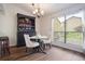 Dining area featuring hardwood floors, modern chandelier, and a large window at 940 Douglas Ave # 159, Altamonte Springs, FL 32714