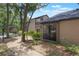 View of townhouse with mulch landscaping and tree-lined street at 940 Douglas Ave # 159, Altamonte Springs, FL 32714