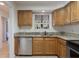 A well-lit kitchen featuring light wood cabinets, stainless steel appliances, and granite countertops at 940 Douglas Ave # 159, Altamonte Springs, FL 32714