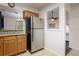A kitchen featuring wooden cabinets, granite countertops, and stainless steel appliances, with an opening to another room at 940 Douglas Ave # 159, Altamonte Springs, FL 32714