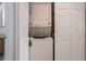 Laundry closet featuring a stacked washer and dryer and additional storage shelves at 940 Douglas Ave # 159, Altamonte Springs, FL 32714