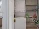Laundry closet featuring a stacked washer and dryer and additional storage shelves at 940 Douglas Ave # 159, Altamonte Springs, FL 32714