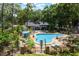 Community pool area with plenty of lounge chairs and shade, surrounded by lush landscaping at 940 Douglas Ave # 159, Altamonte Springs, FL 32714