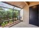 Enclosed porch with view of backyard landscaping and access door at 940 Douglas Ave # 159, Altamonte Springs, FL 32714