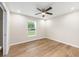Bright bedroom has a ceiling fan, wood-look floors, neutral walls, and a window at 1059 Ne 130Th Ter, Silver Springs, FL 34488