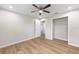 Bedroom featuring wood-look flooring, a ceiling fan, and a walk-in closet at 1059 Ne 130Th Ter, Silver Springs, FL 34488