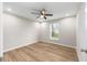 Bright bedroom featuring a ceiling fan, natural light, and wood-look flooring at 1059 Ne 130Th Ter, Silver Springs, FL 34488