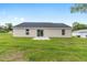 Exterior view of backyard with sliding glass door and ample yard at 1059 Ne 130Th Ter, Silver Springs, FL 34488