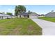 Traditional single-story home with an attached garage and a freshly poured concrete driveway at 1059 Ne 130Th Ter, Silver Springs, FL 34488