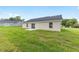 Exterior view of home with sliding glass doors and ample yard at 1059 Ne 130Th Ter, Silver Springs, FL 34488