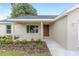 Inviting front porch with newly landscaped flowerbeds and a walkway to the home's front door at 1059 Ne 130Th Ter, Silver Springs, FL 34488
