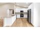Bright kitchen features stainless steel appliances, white cabinets, and granite countertops at 1059 Ne 130Th Ter, Silver Springs, FL 34488