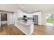 Open kitchen boasts stainless steel appliances, granite counters, and an island with a sink at 1059 Ne 130Th Ter, Silver Springs, FL 34488