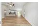 Bright open-plan living room with vaulted ceiling, ceiling fan, and modern wood-look flooring at 1059 Ne 130Th Ter, Silver Springs, FL 34488