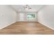 Spacious living area featuring a ceiling fan, wood-look flooring, and natural light at 1059 Ne 130Th Ter, Silver Springs, FL 34488