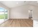 Bright living room featuring vaulted ceilings, modern flooring, and sliding glass doors at 1059 Ne 130Th Ter, Silver Springs, FL 34488