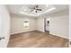 Spacious main bedroom featuring tray ceiling, ceiling fan, wood-look flooring, and ensuite bathroom at 1059 Ne 130Th Ter, Silver Springs, FL 34488