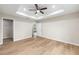 Light-filled main bedroom with wood floors, tray ceiling and access to closet and doorway at 1059 Ne 130Th Ter, Silver Springs, FL 34488