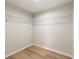 Empty walk-in closet with wood-look floors and wire shelving at 1059 Ne 130Th Ter, Silver Springs, FL 34488