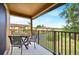 Relaxing balcony with a seating area, overlooking a green space and other residential buildings at 109 Cambria Ave, Davenport, FL 33897