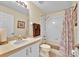 A bathroom with a shower, toilet, and vanity with an integrated sink at 109 Cambria Ave, Davenport, FL 33897