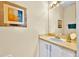 Well-lit half bathroom with a framed mirror and a single sink vanity, perfect for guests at 109 Cambria Ave, Davenport, FL 33897