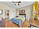 Cozy bedroom features laminate floors, a comfortable bed, and a well-lit workspace with a connected bathroom at 109 Cambria Ave, Davenport, FL 33897
