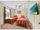A bedroom with two twin beds, a window, and a TV at 109 Cambria Ave, Davenport, FL 33897