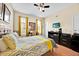 Bright bedroom with a ceiling fan, a comfortable queen bed, and a convenient workstation for remote work or study at 109 Cambria Ave, Davenport, FL 33897