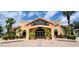 Front view of the Regal Palms Bar, Restaurant, and Spa clubhouse, set against a sunny sky at 109 Cambria Ave, Davenport, FL 33897