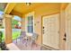 Inviting covered front porch with comfortable seating for enjoying the outdoors at unit 109 at 109 Cambria Ave, Davenport, FL 33897