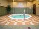 Indoor hot tub with tiled surroundings, spa rules posted, and easy access to emergency services at 109 Cambria Ave, Davenport, FL 33897