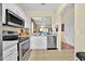 Efficient kitchen with white cabinets, stainless steel appliances, and an open design for easy meal preparation at 109 Cambria Ave, Davenport, FL 33897