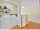 A laundry room with a side-by-side washer and dryer and shelving at 109 Cambria Ave, Davenport, FL 33897