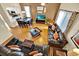 A living room with hardwood floors, multiple sofas, and a view into the kitchen at 109 Cambria Ave, Davenport, FL 33897