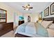 Spacious main bedroom with ceiling fan, dresser, television, walk-in closet, and a comfortable bed at 109 Cambria Ave, Davenport, FL 33897