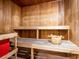 Inviting sauna room with wooden benches and a classic wooden bucket for a relaxing experience at 109 Cambria Ave, Davenport, FL 33897