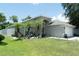 Well-maintained home with palm trees, a manicured lawn, and attractive landscaping at 11761 Hatcher Cir, Orlando, FL 32824