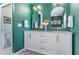 Bathroom with a double sink vanity, white cabinets and brushed gold hardware at 1219 Oakley St, Orlando, FL 32806