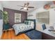 Bedroom with a ceiling fan, hardwood floors, and bright windows at 1219 Oakley St, Orlando, FL 32806