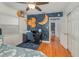 Fun bedroom featuring unique celestial wallpaper, hardwood floors, a desk, and a wooden cat tower at 1219 Oakley St, Orlando, FL 32806