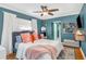 Cozy bedroom with a ceiling fan, large window and hardwood flooring at 1219 Oakley St, Orlando, FL 32806