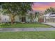 Charming home with lush landscaping, manicured lawn, and a quaint facade at 1219 Oakley St, Orlando, FL 32806