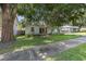 Landscaped home featuring a well-manicured lawn and mature shade trees at 1219 Oakley St, Orlando, FL 32806