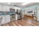 View of open floor plan kitchen with stainless steel appliances and a blue backsplash at 1219 Oakley St, Orlando, FL 32806
