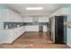 Spacious kitchen features white cabinets, stainless steel appliances and mosaic backsplash at 1219 Oakley St, Orlando, FL 32806